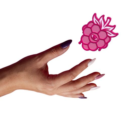 An open hand releasing a berry.